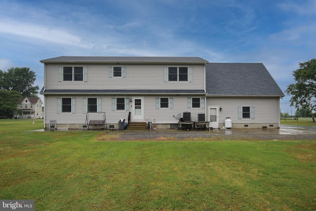 rear view of property with a yard