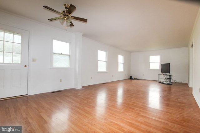 unfurnished living room with ceiling fan, light hardwood / wood-style floors, and ornamental molding