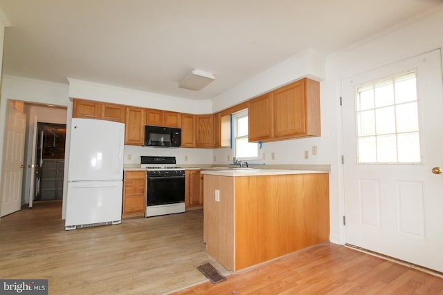 kitchen with light hardwood / wood-style floors, white appliances, kitchen peninsula, and ornamental molding