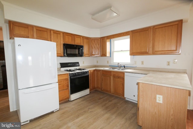 kitchen with sink, kitchen peninsula, light hardwood / wood-style floors, white appliances, and ornamental molding