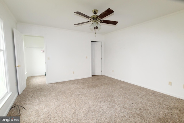 interior space with light colored carpet, ceiling fan, and ornamental molding