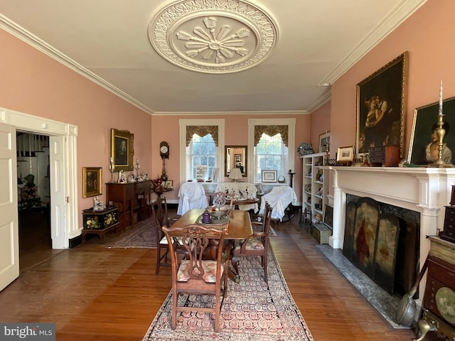 dining area with a fireplace, dark hardwood / wood-style floors, and crown molding