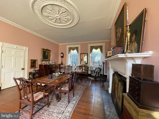 dining space featuring ornamental molding and hardwood / wood-style floors