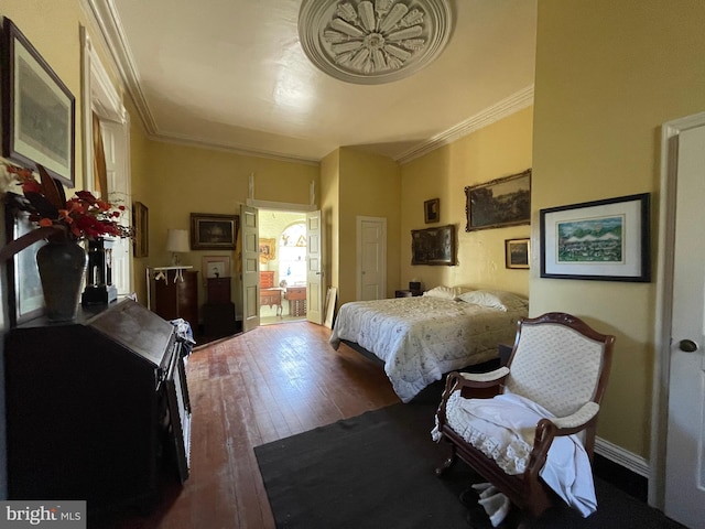 bedroom featuring dark wood-type flooring and ornamental molding