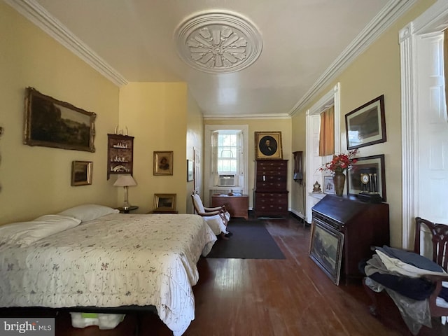 bedroom featuring crown molding and dark hardwood / wood-style flooring