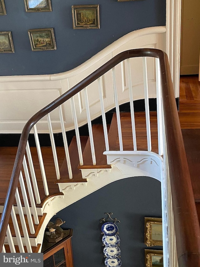 stairs with hardwood / wood-style flooring