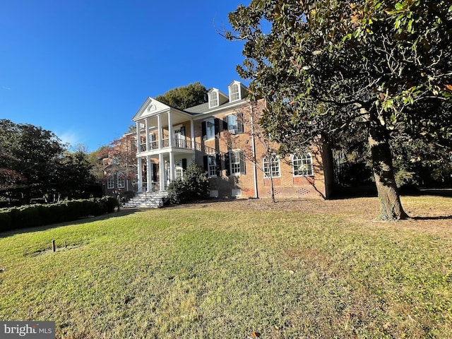 exterior space with a lawn and a balcony