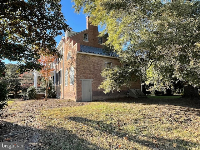 view of side of property with a yard