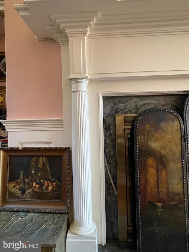 room details featuring ornate columns and a fireplace