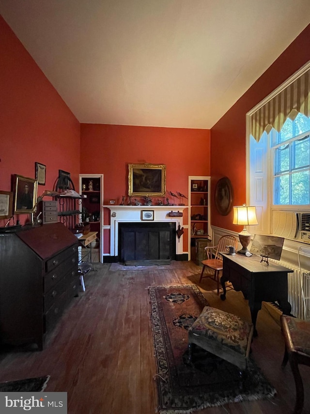 living room featuring vaulted ceiling, radiator heating unit, and dark hardwood / wood-style flooring