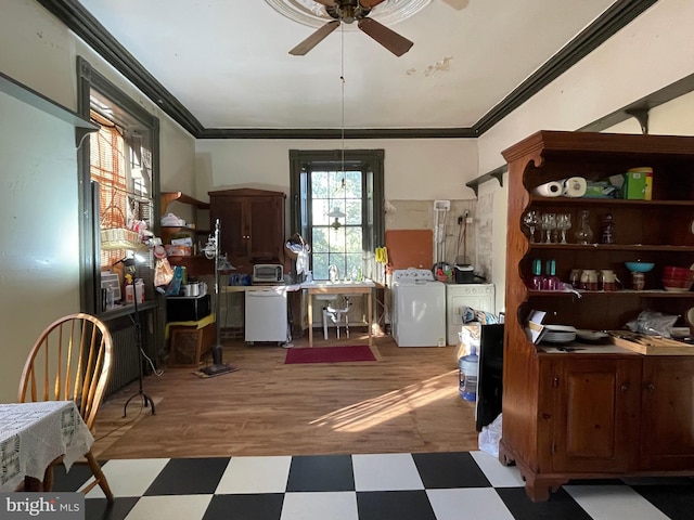 office area featuring ceiling fan, light wood-type flooring, ornamental molding, and washer and dryer