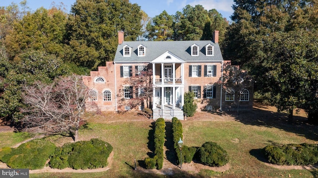 view of front of property with a front lawn and a balcony