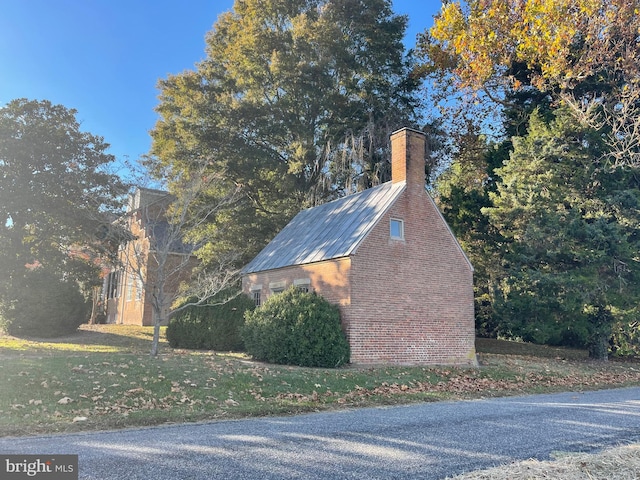 view of side of home with a lawn