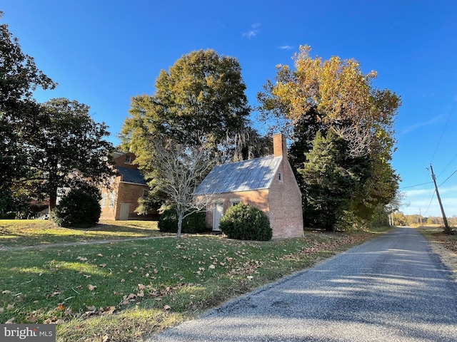 view of side of home featuring a yard