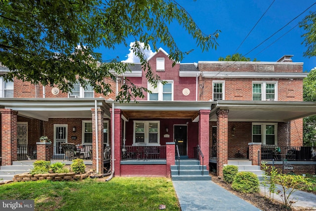 townhome / multi-family property featuring a porch