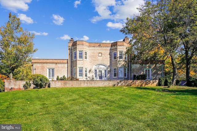 view of front of home with a front yard and french doors