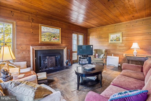 living room featuring wooden ceiling and wood walls