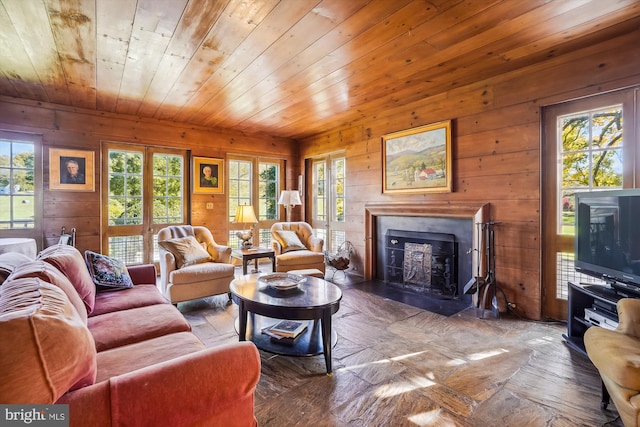 living room with wooden walls and wooden ceiling