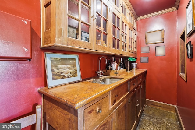 bar with crown molding and sink