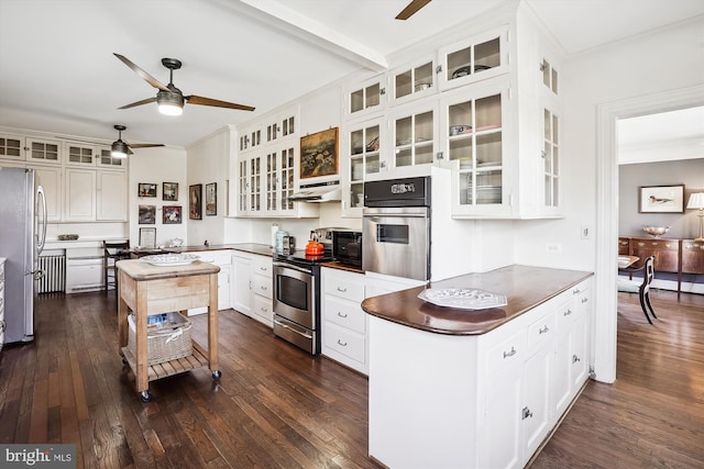 kitchen with kitchen peninsula, white cabinetry, dark wood-type flooring, and appliances with stainless steel finishes