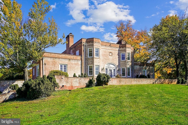 back of property featuring a yard