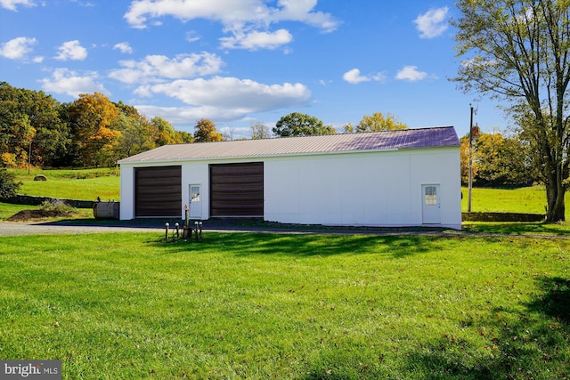 view of outbuilding with a yard and a garage