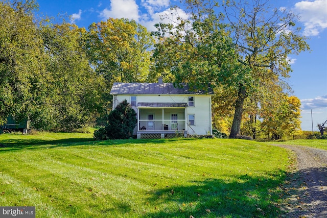 view of front of house with a porch and a front yard