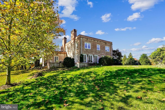 back of house with a yard