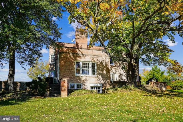 rear view of property featuring a yard