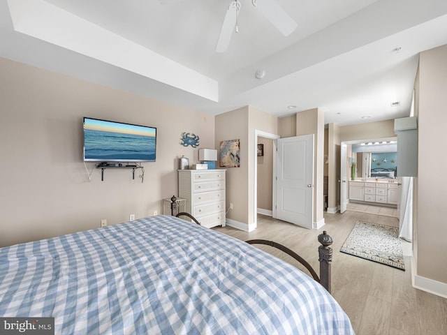 bedroom with ceiling fan, ensuite bathroom, and light hardwood / wood-style floors