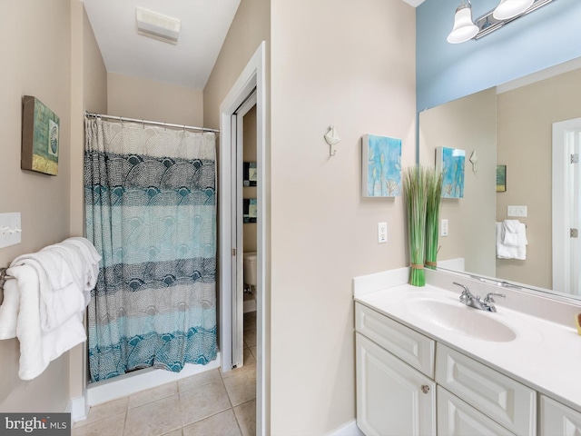 bathroom featuring tile floors, toilet, and vanity