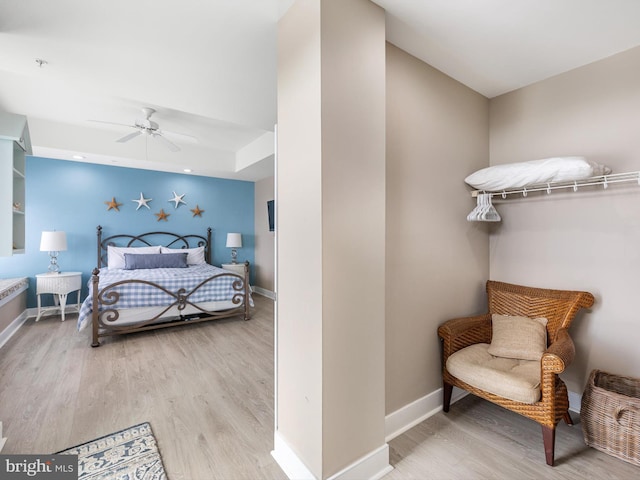 bedroom with light hardwood / wood-style floors and ceiling fan