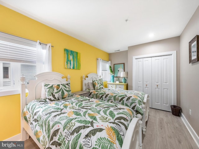 bedroom with a closet and light hardwood / wood-style flooring