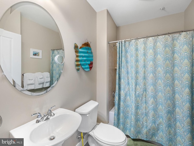 full bathroom with toilet, shower / tub combo with curtain, and sink