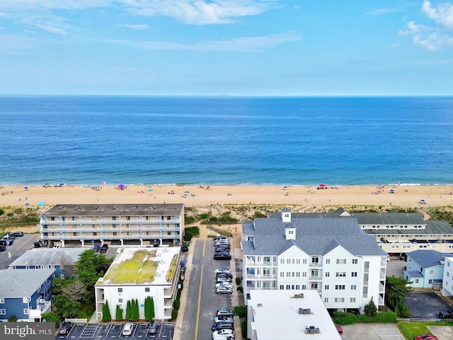 drone / aerial view featuring a beach view and a water view