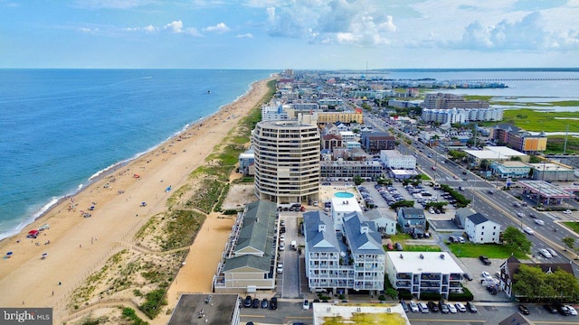 aerial view with a water view and a beach view