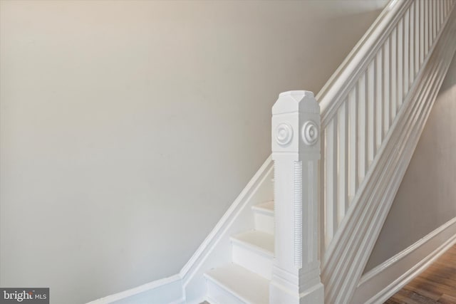 stairs featuring hardwood / wood-style flooring