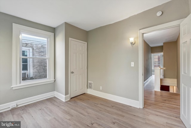 spare room with light hardwood / wood-style floors