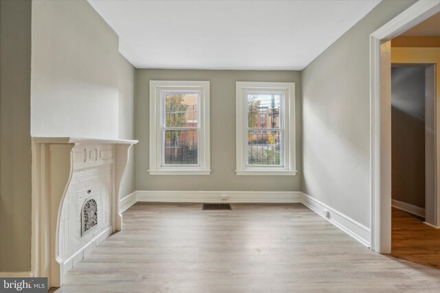 unfurnished living room featuring light wood-type flooring