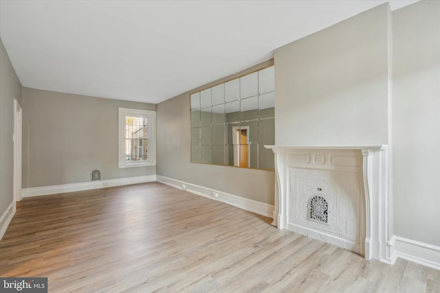 unfurnished living room featuring a fireplace and light wood-type flooring