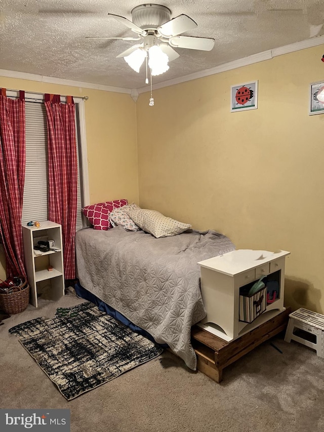 bedroom featuring ceiling fan, dark colored carpet, ornamental molding, and a textured ceiling