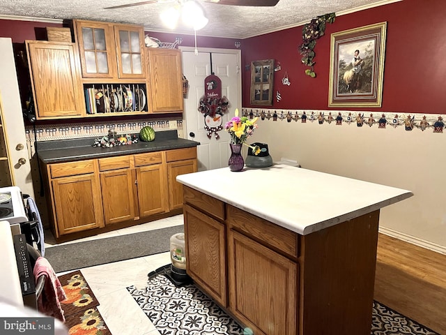 kitchen with ceiling fan, light tile floors, and a textured ceiling