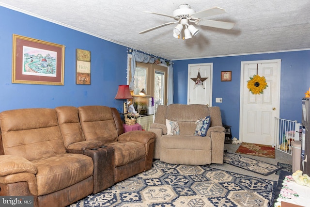 living room with ceiling fan, a textured ceiling, and crown molding