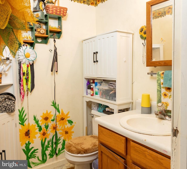 bathroom featuring vanity and toilet