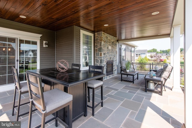 view of patio / terrace featuring an outdoor stone fireplace