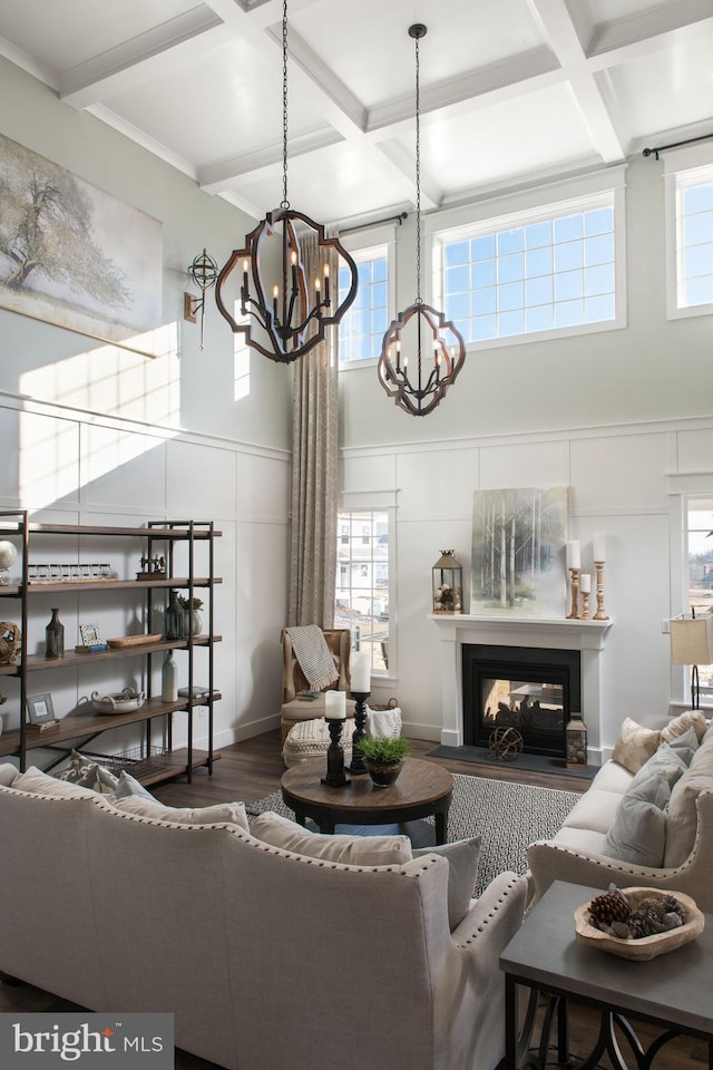 living room with coffered ceiling, hardwood / wood-style floors, beam ceiling, and a multi sided fireplace