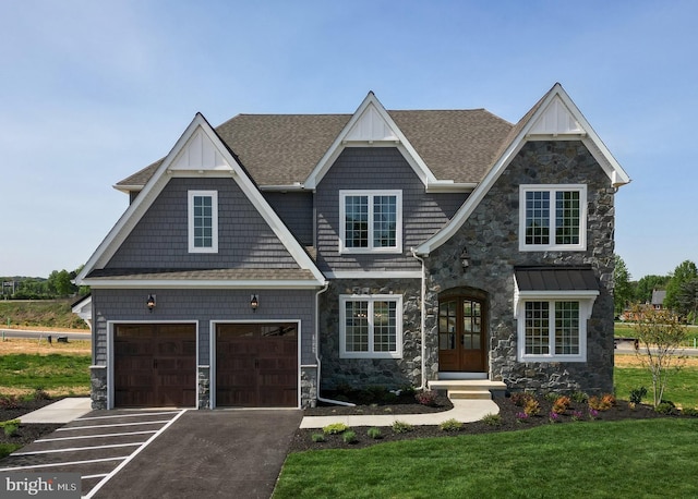 view of front of property with an attached garage, roof with shingles, french doors, stone siding, and driveway