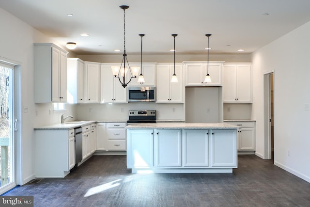 kitchen with white cabinetry, dark wood-style flooring, appliances with stainless steel finishes, and a center island