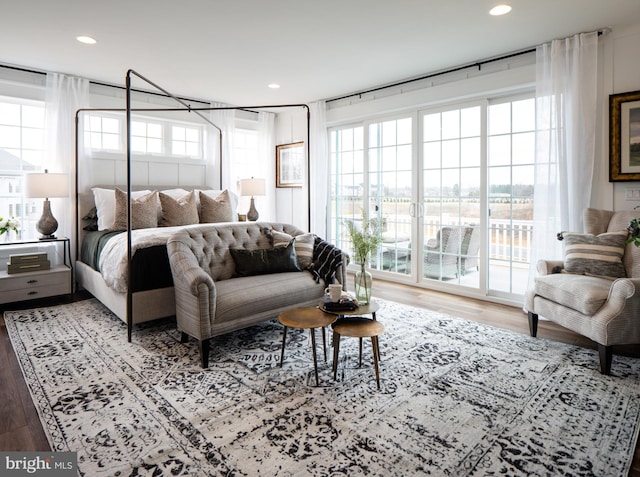 bedroom featuring recessed lighting, wood finished floors, and access to outside