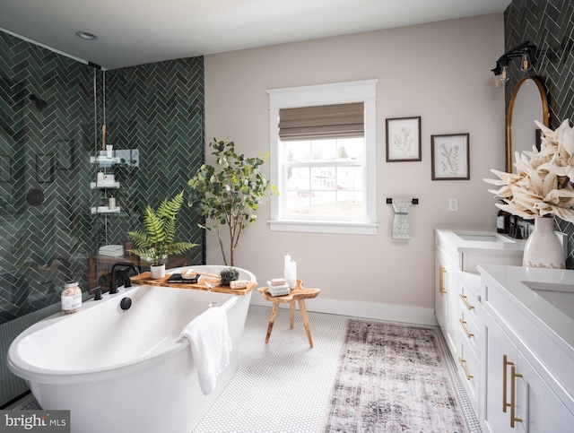 bathroom with a tile shower, a freestanding bath, tile walls, and double vanity
